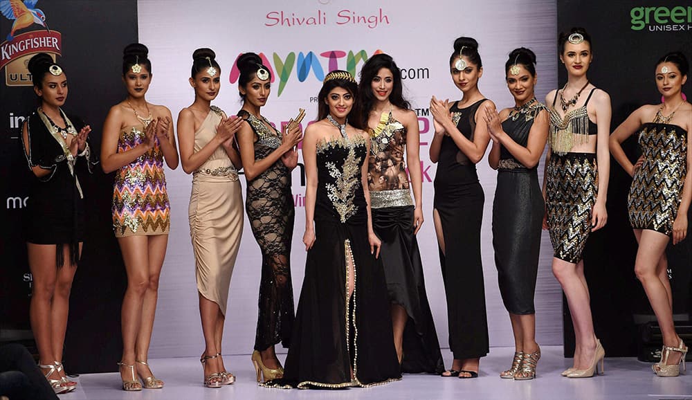 Actor Praneeta Subhash with designer Shivali Singh on the ramp during the first day of Bangalore Fashion Week in Bengaluru.