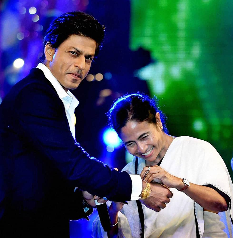 West Bengal Chief Minister Mamata Banerjee ties Rakhi on the wrist of Bollywood actor Shahrukh Khan to celebrate 'Rakshabandhan'during Kolkata Police Programme in Kolkata.