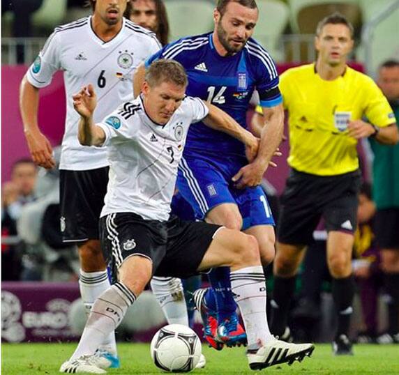 Germany's Bastian Schweinsteiger controlls the ball in front of Greece's Dimitris Salpigidis during the Euro 2012 soccer championship quarterfinal match between Germany and Greece.