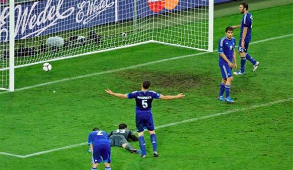 Greece's Kyriakos Papadopoulos, center, gestures after Germany scored their fourth goal during the Euro 2012 soccer championship quarterfinal match between Germany and Greece in Gdansk.