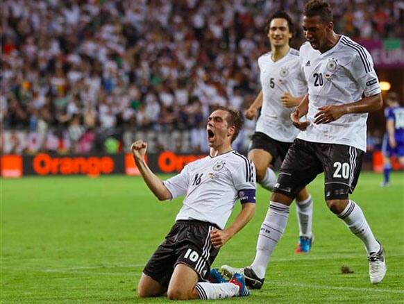 Germany's Philipp Lahm, left, celebrates after scoring during the Euro 2012 soccer championship quarterfinal match between Germany and Greece.