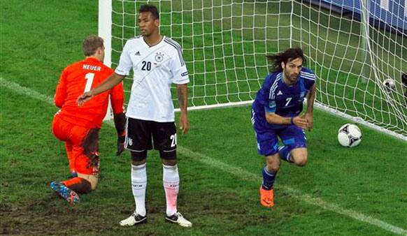 Germany goalkeeper Manuel Neuer, left, and Jerome Boateng react after Greece's Giorgos Samaras scored his side's first goal during the Euro 2012 soccer championship quarterfinal match between Germany and Greece.