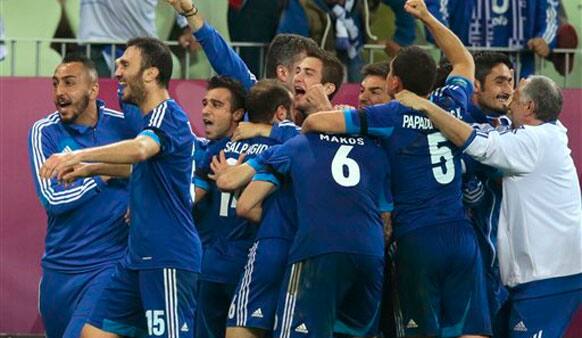 Greek team celebrate after Giorgos Samaras scored during the Euro 2012 soccer championship quarterfinal match between Germany and Greece.