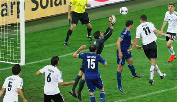 Germany's Miroslav Klose, right, scores his side's third goal during the Euro 2012 soccer championship quarterfinal match between Germany and Greece in Gdansk.