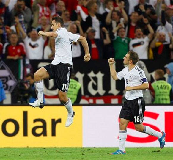 Germany's Miroslav Klose, left, celebrates after scoring his side's third goal during the Euro 2012 soccer championship quarterfinal match between Germany and Greece in Gdansk.