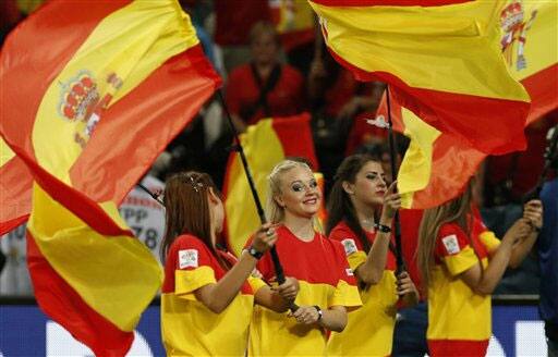 Soccer enthusiasts wave Spanish flags prior to the Euro 2012 soccer championship quarterfinal match between Spain and France in Donetsk, Ukraine, Saturday, June 23, 2012.