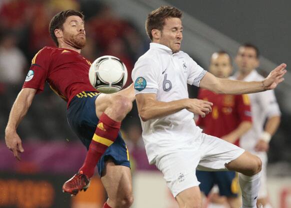 rance's Yohan Cabaye, right, and Spain's Xabi Alonso go for the ball during the Euro 2012 soccer championship quarterfinal match between Spain and France in Donetsk, Ukraine, Saturday, June 23, 2012.