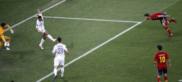 Spain's Xabi Alonso, right, scores the opening goal past France goalkeeper Hugo Lloris during the Euro 2012 soccer championship quarterfinal match between Spain and France in Donetsk, Ukraine, Saturday, June 23, 2012.