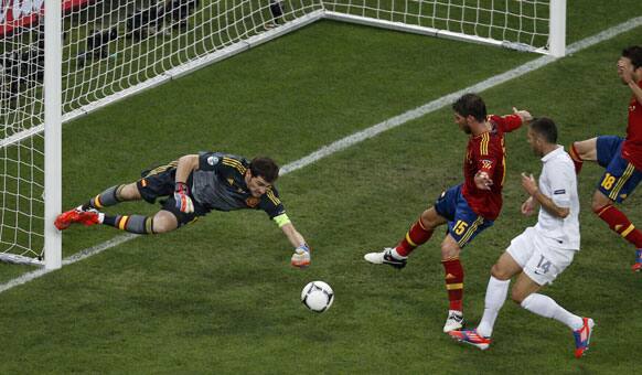 Spain goalkeeper Iker Casillas, left, deflects a ball during the Euro 2012 soccer championship quarterfinal match between Spain and France in Donetsk, Ukraine, Saturday, June 23, 2012. 