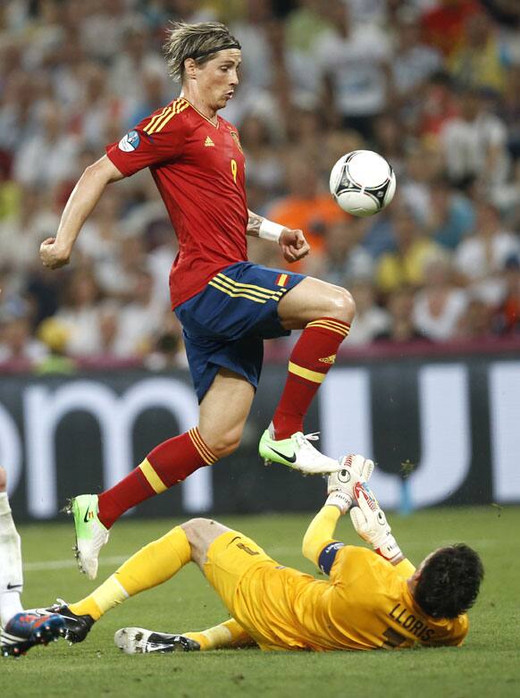 France goalkeeper Hugo Lloris saves on Spain's Fernando Torres during the Euro 2012 soccer championship quarterfinal match between Spain and France in Donetsk, Ukraine, Saturday, June 23, 2012.