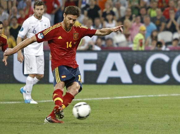 Spain's Xabi Alonso scores on a penalty kick his side's second goal during the Euro 2012 soccer championship quarterfinal match between Spain and France in Donetsk, Ukraine, Saturday, June 23, 2012.