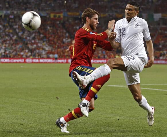 Spain's Sergio Ramos, left, and France's Gael Clichy challenge for the ball during the Euro 2012 soccer championship quarterfinal match between Spain and France in Donetsk, Ukraine.