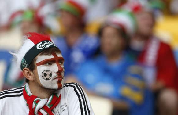 An England supporter waits for the kick-off of the Euro 2012 soccer championship quarterfinal match between England and Italy in Kiev, Ukraine, Sunday, June 24, 2012.