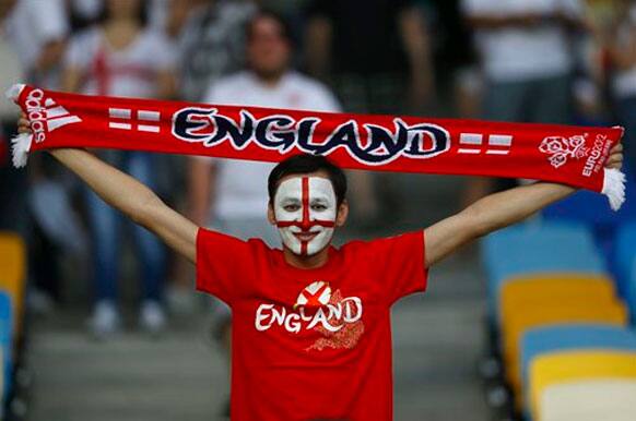 An English fan cheers as he waits for the kick-off of the Euro 2012 soccer championship quarterfinal match between England and Italy in Kiev, Ukraine, Sunday, June 24, 2012.