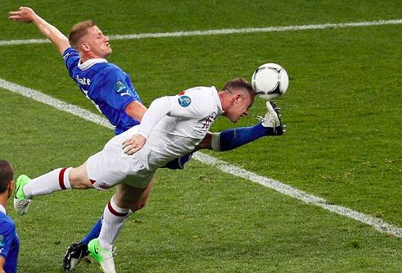 Italy's Ignazio Abate, left, and England's Wayne Rooney go for the ball during the Euro 2012 soccer championship quarterfinal match between England and Italy in Kiev, Ukraine.