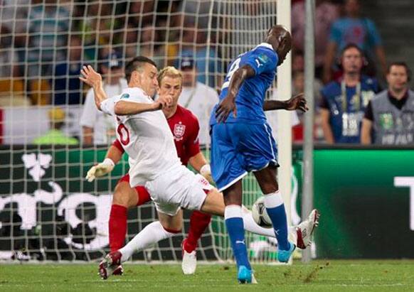 Italy's Mario Balotelli misses a scoring chance, blocked by England's John Terry during the Euro 2012 soccer championship quarterfinal match between England and Italy in Kiev, Ukraine.