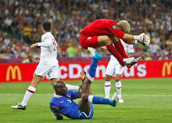 England goalkeeper Joe Hart jumps over Italy's Mario Balotelli during the Euro 2012 soccer championship quarterfinal match between England and Italy in Kiev, Ukraine, Sunday.