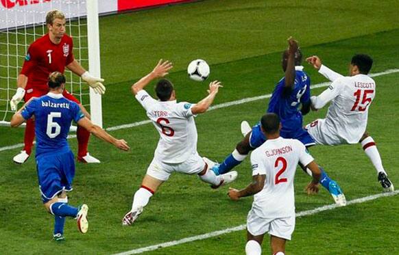 Italy's Mario Balotelli, second right, fails to score past England goalkeeper Joe Hart, left, during the Euro 2012 soccer championship quarterfinal match between England and Italy in Kiev, Ukraine.