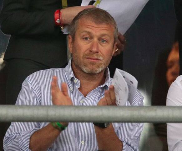 Chelsea owner Roman Abramovich applauds during the Euro 2012 soccer championship quarterfinal match between England and Italy in Kiev, Ukraine.