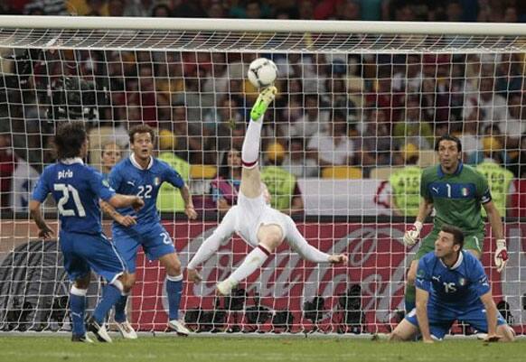 England's Wayne Rooney performs an overhead kick at goal during the Euro 2012 soccer championship quarterfinal match between England and Italy in Kiev, Ukraine.