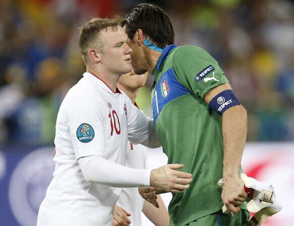 England's Wayne Rooney, left, and Italy goalkeeper Gianluigi Buffon exchange the word at the end of the Euro 2012 soccer championship quarterfinal match between England and Italy in Kiev, Ukraine.