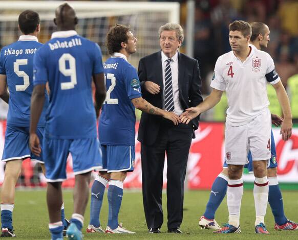 England manager Roy Hodgson, center and Steven Gerrard, right, greet Italy's Alessandro Diamanti who scored the decisive penalty shootout during the Euro 2012 soccer championship quarterfinal match between England and Italy in Kiev, Ukraine.