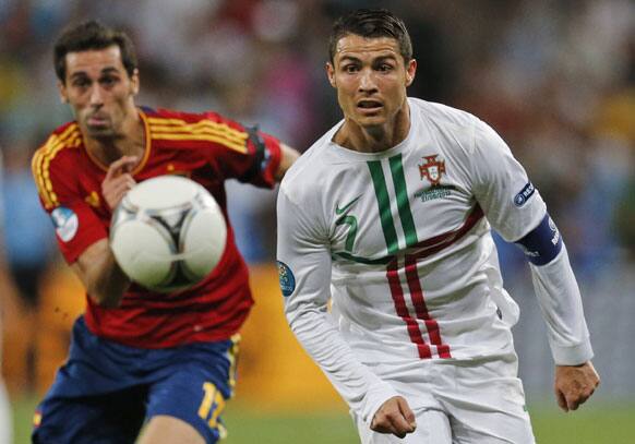 Portugal's Cristiano Ronaldo, right, and Spain's Alvaro Arbeloa run for the ball during the Euro 2012 soccer championship semifinal match between Spain and Portugal in Donetsk, Ukraine, Wednesday, June 27, 2012.