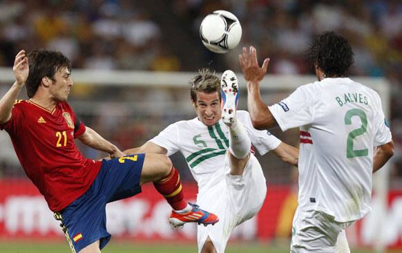 Portugal's Fabio Coentrao kicks the ball, challenged by Spain's David Silva, left, during the Euro 2012 soccer championship semifinal match between Spain and Portugal in Donetsk, Ukraine, Wednesday, June 27, 2012. 