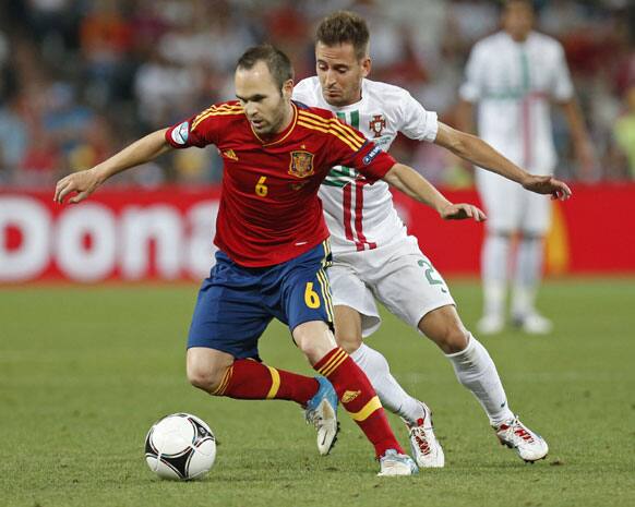 Spain's Andres Iniesta and Portugal's Joao Pereira challenge for the ball during the Euro 2012 soccer championship semifinal match between Spain and Portugal in Donetsk, Ukraine, Wednesday, June 27, 2012.