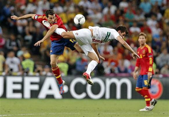 Spain's Alvaro Arbeloa left, and Portugal's Nelson Oliveira jump for the ball during the Euro 2012 soccer championship semifinal match between Spain and Portugal in Donetsk, Ukraine, Wednesday, June 27, 2012. 