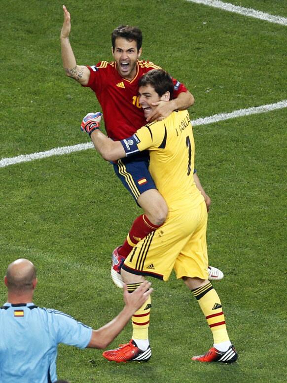 Spain's Cesc Fabregas, left, celebrates with goalkeeper Iker Casillas after scoring the decisive goal in the penalty shootout of the Euro 2012 soccer championship semifinal match between Spain and Portugal in Donetsk, Ukraine, Thursday, June 28, 2012.