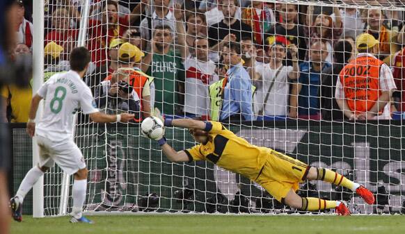 Spain goalkeeper Iker Casillas saves a penalty from Portugal's Joao Moutinho during a penalty shootout in the Euro 2012 soccer championship semifinal match between Spain and Portugal in Donetsk.