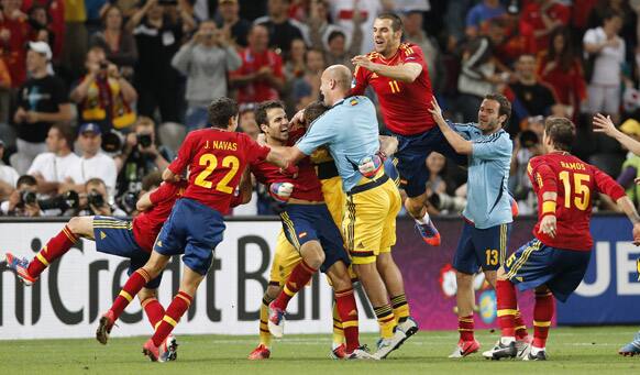 Spanish players celebrate after Cesc Fabregas, center, scored the decisive goal in the penalty shootout of the Euro 2012 soccer championship semifinal match between Spain and Portugal in Donetsk, Ukraine.