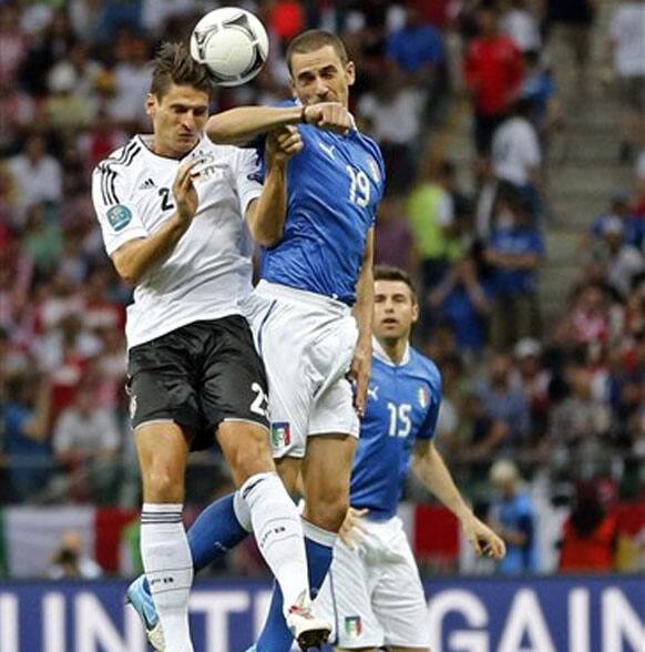 Germany's Ilkay Guendogan, left, and Italy's Leonardo Bonucci jump for the ball during the Euro 2012 soccer championship semifinal match between Germany and Italy in Warsaw, Poland, Thursday, June 28, 2012. 