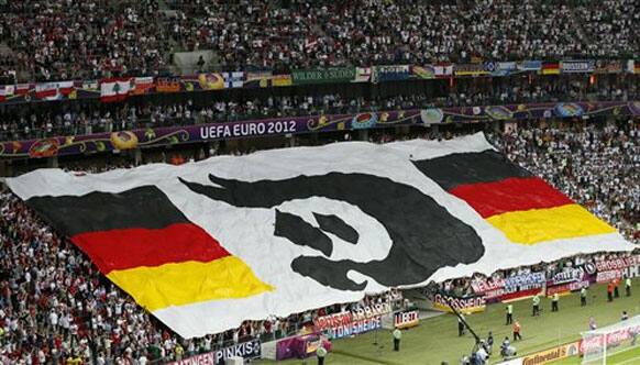 Fans hold a giant banner with the German colors prior to the Euro 2012 soccer championship semifinal match between Germany and Italy in Warsaw, Poland, Thursday, June 28, 2012. 