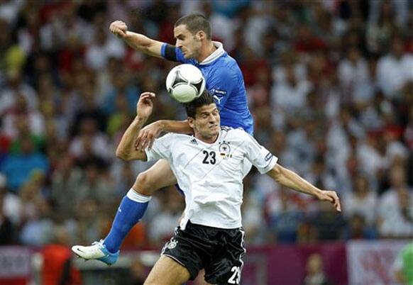 Italy's Leonardo Bonucci, back, and Germany's Mario Gomez go for a header during the Euro 2012 soccer championship semifinal match between Germany and Italy in Warsaw, Poland, Thursday, June 28, 2012. 