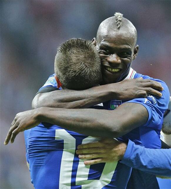 Italy's Mario Balotelli, front, and Antonio Cassano celebrate their first goal during the Euro 2012 soccer championship semifinal match between Germany and Italy in Warsaw, Poland, Thursday, June 28, 2012. 