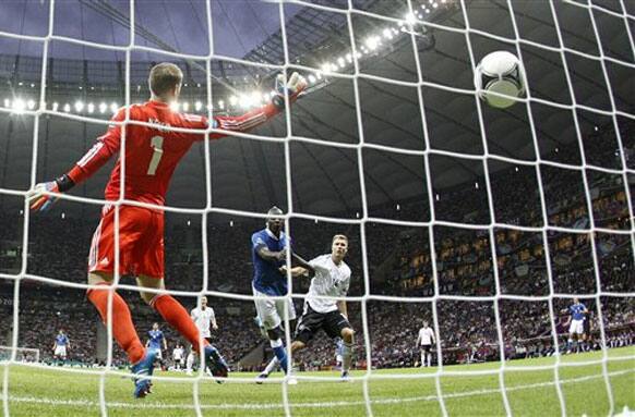 Italy's Mario Balotelli scores the first goal during the Euro 2012 soccer championship semifinal match between Germany and Italy in Warsaw, Poland, Thursday, June 28, 2012. (