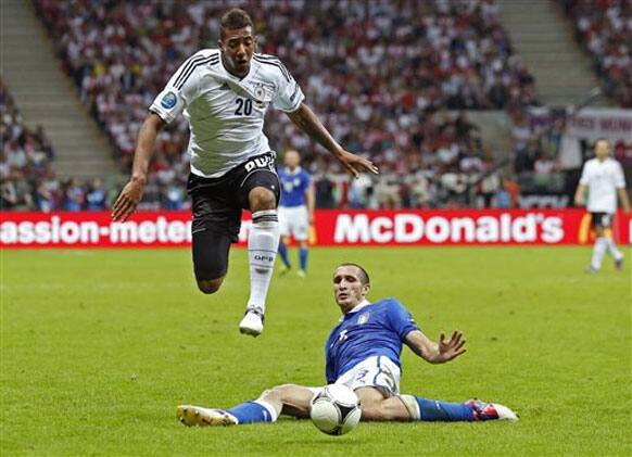 Germany's Jerome Boateng jumps past Italy's Giorgio Chiellini during the Euro 2012 soccer championship semifinal match between Germany and Italy in Warsaw, Poland, Thursday, June 28, 2012. 