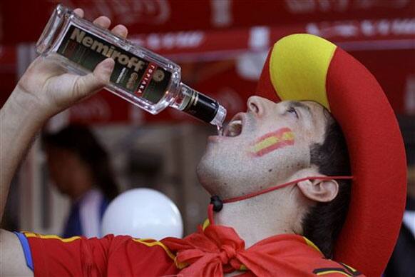 A Spain supporter drinks vodka ahead of the Euro 2012 soccer championship final match between Spain and Italy in Kiev, Ukraine, Sunday, July 1, 2012.