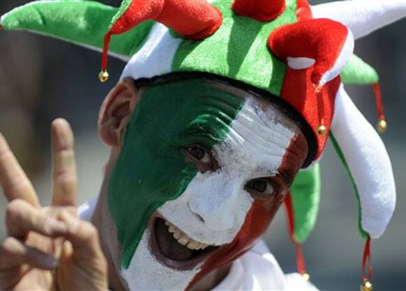 An Italian soccer fan cheers for his team ahead of the Euro 2012 soccer championship final match between Spain and Italy in Kiev, Ukraine, Sunday, July 1, 2012.