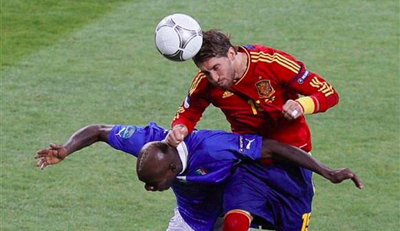 Italy's Mario Balotelli, bottom, and Spain's Sergio Ramos go for a header during the Euro 2012 soccer championship final between Spain and Italy in Kiev.