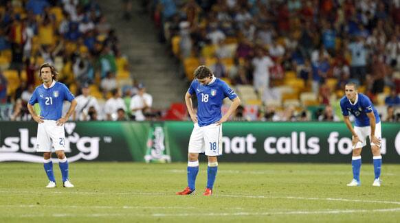 Italian players Andrea Pirlo, Riccardo Montolivo and Leonardo Bonucci, from left, stand dejected after Spain scored the second goal during the Euro 2012 soccer championship final between Spain and Italy in Kiev, Ukraine, Sunday, July 1, 2012. 