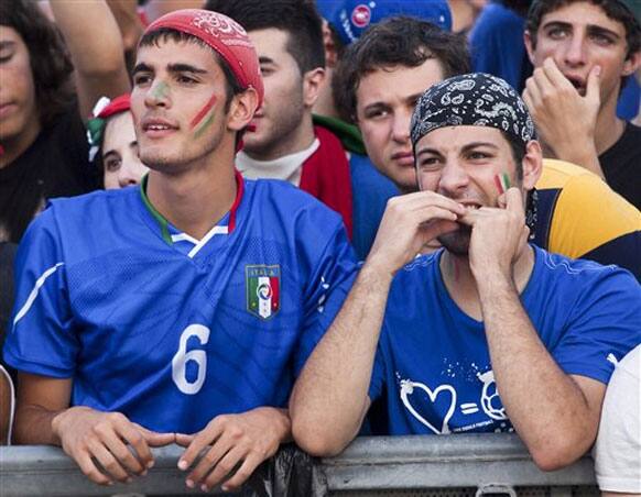 Italian supporters react as they watch the final of the Euro 2012 soccer championships between Italy and Spain televised on a giant screen set up in Rome's Circus Maximus archaeological area, Sunday, July 1, 2012.