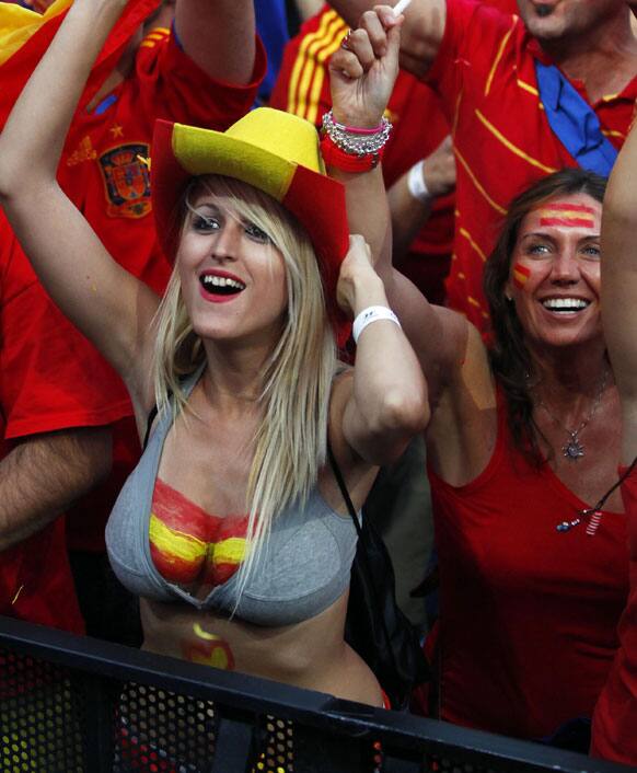 Spanish fans celebrate during the viewing of Euro 2012 soccer championship final match between Spain and Italy at the Fan Zone in Madrid, Spain, Sunday, July 1, 2012. 