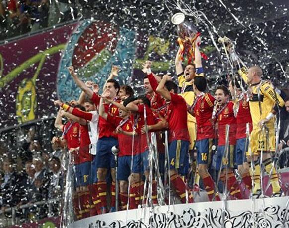 Spanish players celebrate with the trophy after the Euro 2012 soccer championship final between Spain and Italy in Kiev, Ukraine, Sunday, July 1, 2012.