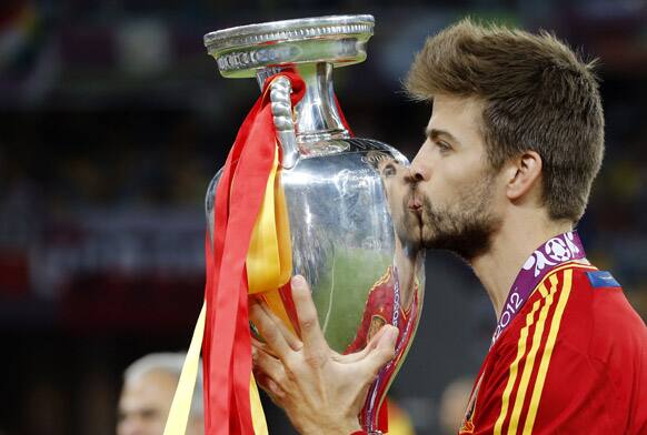 Spain's Gerard Pique kiss the trophy at the end of the Euro 2012 soccer championship final between Spain and Italy in Kiev, Ukraine.