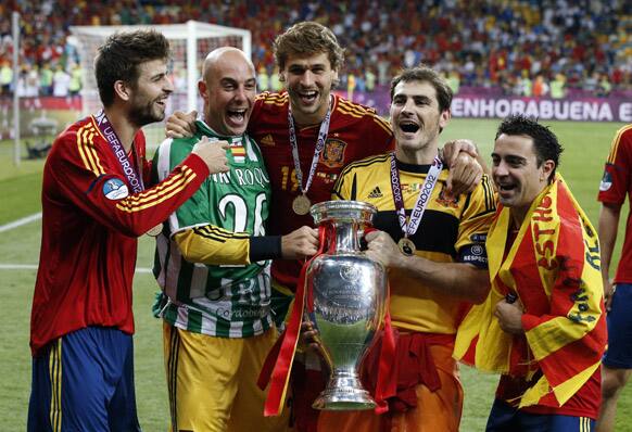 Spain's Gerard Pique, goalkeeper Pepe Reina, Fernando Llorente goalkeeper Iker Casillas and Xavi Hernandez, from left, celebrate with the trophy after winning the Euro 2012 soccer championship final between Spain and Italy in Kiev, Ukraine.