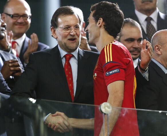 Spain's Pedro Rodriguez is congratulated by Spanish Prime Minister Mariano Rajoy after the Euro 2012 soccer championship final between Spain and Italy in Kiev, Ukraine.