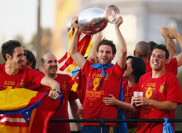 Juan Matta holds the trophy with teammates during the celebration of the Euro 2012 soccer championship in Madrid.